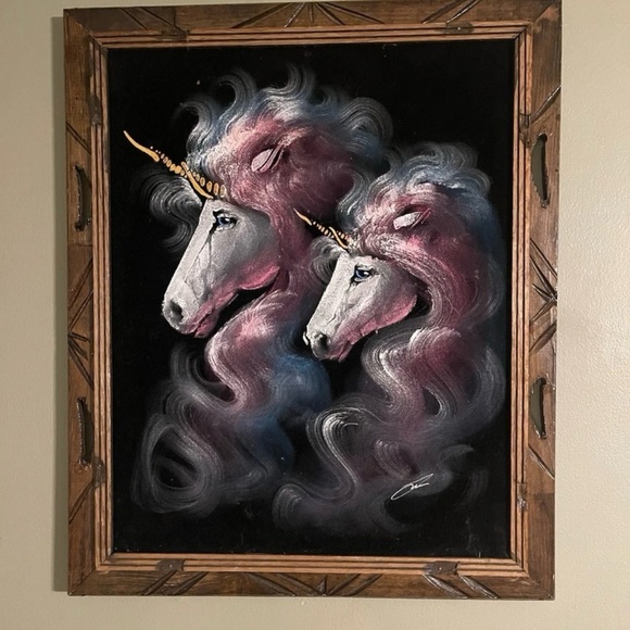 Mystical unicorns on black velvet .
